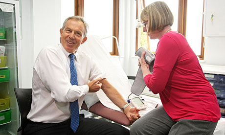 Tony Blair has his blood pressure taken by a nurse at a health centre in Harrow, north London