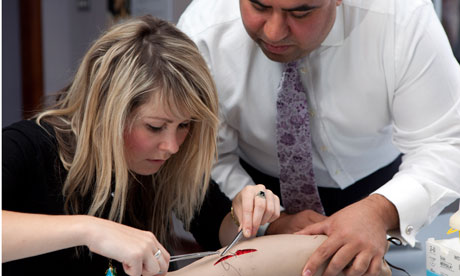 Perri Lewis learning to suture with Mr Akan Emin