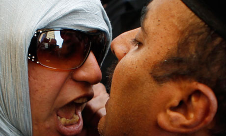An anti-government protester clashes with a policeman in Cairo. Photograph: Amr Abdallah Dalsh/Reuters