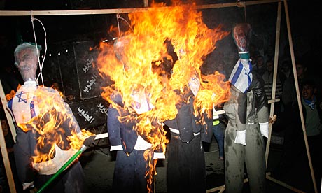 Effigies with Israeli flags of images of Mahmoud Abbas are burned in a Hamas-led protest in Gaza.
