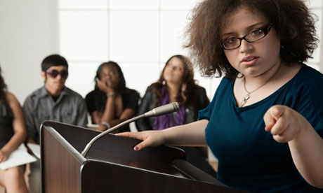 Teenage girl giving speech to classmates