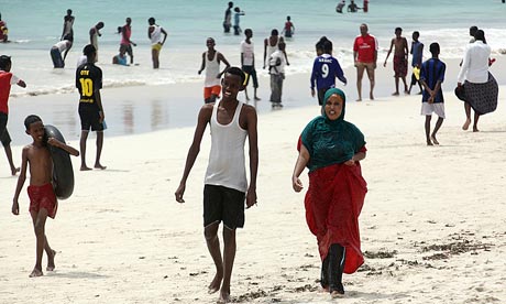 Somali youths walk and play along the beachside on the outskirts of Mogadishu