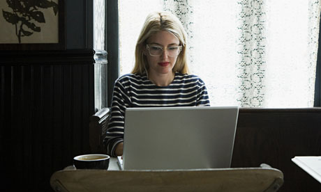 woman working on her laptop in a coffee shop