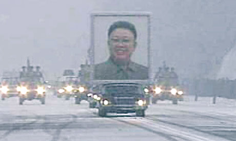 A limousine carrying a portrait of late North Korean leader Kim Jong-il leads his funeral procession