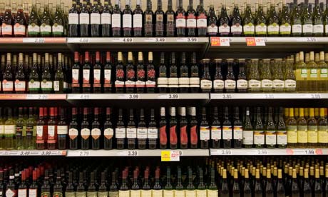 Bottles of cheap red wine on shelves in a budget supermarket in the UK