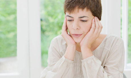 Woman paying bills and looking worried