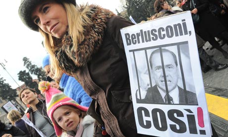 A mother holds a placard reading