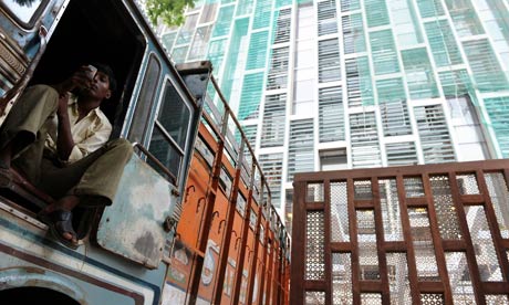 TOPSHOTS A worker checks his mobile phon