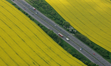 The M4 motorway surrounded by rapeseed fields at Tormarton, near Tetbury, England.