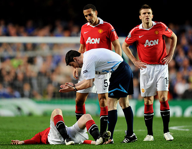 Chelsea v Man Utd: The referee urges Wayne Rooney to get up after being fouled