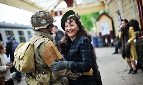 A couple wait to board an East Lancashire steam train during the 1940's re-enactment weekend