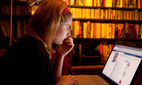 A teenage girl reading her Facebook page