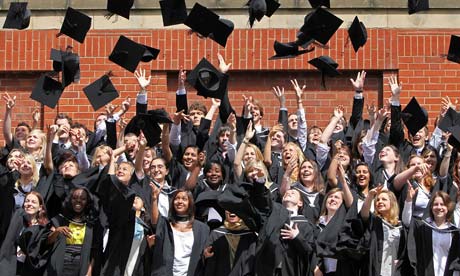 Students throw their mortarboards in the air