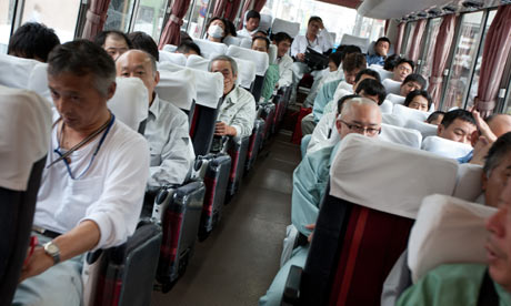 Workers on the bus which will transfer them to the Fukushima Daiichi nuclear plant