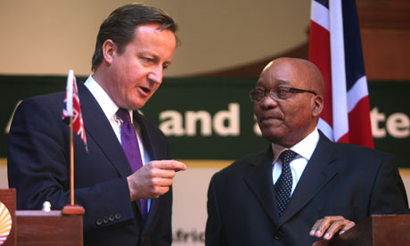 MDG : South African President Zuma listens to David Cameron during a press conference in Pretoria