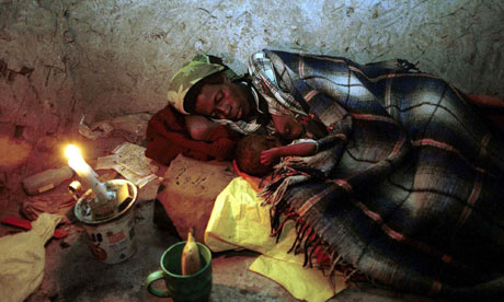 MDG : Swaziland / A woman with Aids with her HIV-infected baby at their home near Magomba, Swaziland