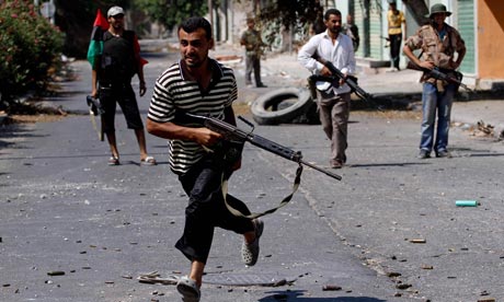 Libyan rebels evade sniper fire in Zawiya, as their forces press in on the capital of Tripoli.