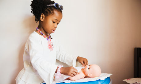 A young girl playing with a doll