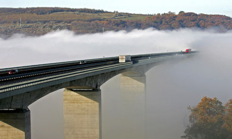 Drivers speed on despite more than half of Hungary's Koroshegy bridge being blanketed in fog.