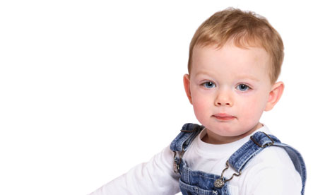 A toddler in overalls