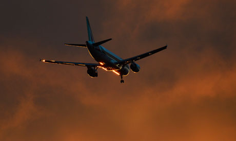 An Alitalia aircraft flies in to land at Heathrow Airport in west London