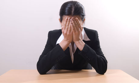Businesswoman crying at her desk 