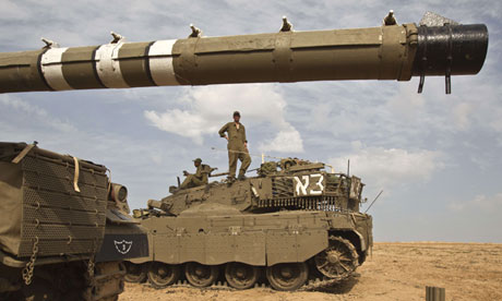 Israeli soldiers take position on the Israeli side of the border with the Gaza Strip