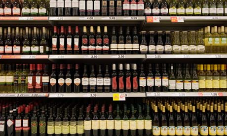 Bottles of cheap red wine on shelves in a budget supermarket in the UK