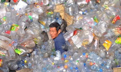 A waste management work sorts plastic bottles