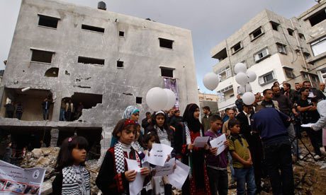 Palestinians release balloons at the site of the bombed Dalou family home