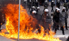 Greece  strikes: A petrol bomb explodes near riot police in Athens