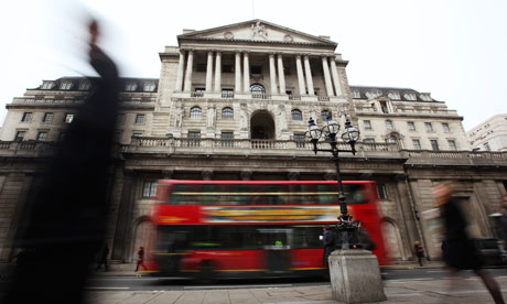 Pedestrians pass The Bank of England in the City of London