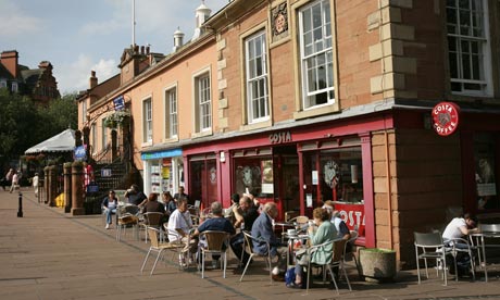 Carlisle shoppers relax with a coffee at the old town hall.