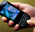 Man holds a Palm Pixi smartphone from Sprint