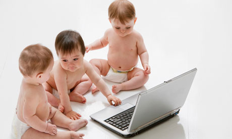 Babies on floor with laptop