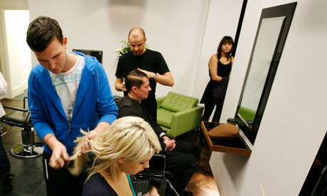 A woman and a man get their hair cut