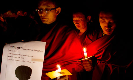 Exiled Tibetan Buddhist monks in a candlelit vigil to mourn the death the two women