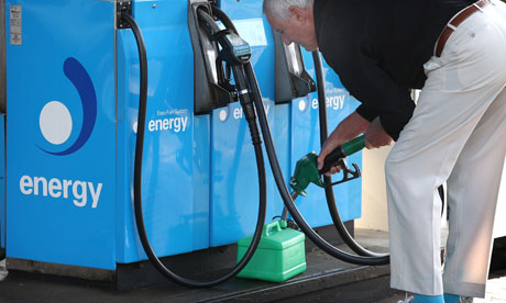 man filling petrol can from fuel pump