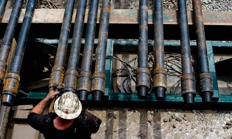 A worker prepares a shale gas drill pipe in Mannington, West Virginia, US