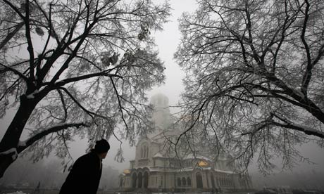 A man walks past the golden domed Alexander Nevski cathedral in Sofia, Bulgaria