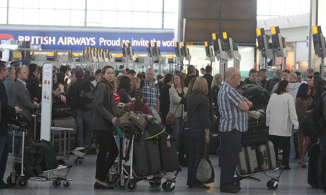 Passengers queuing at check-in desks in Terminal 5 at Heathrow airport