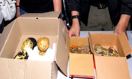 Thai police show the remains of six foetuses wrapped in gold leaf at a news conference in Bangkok.