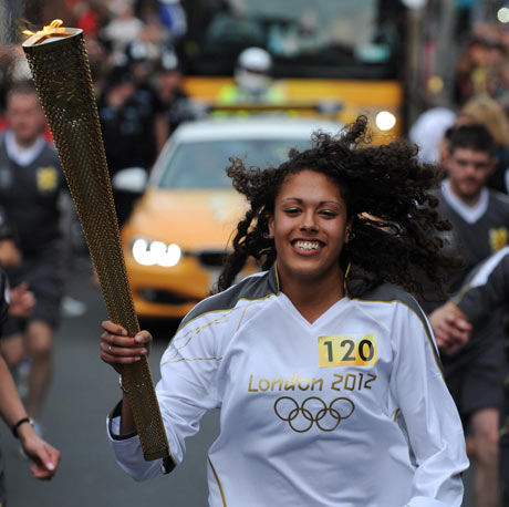 Garnet Mackinder carries the Olympic flame through Exeter, May 2012