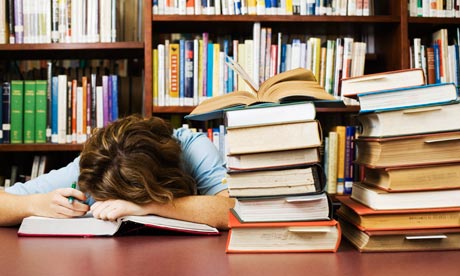 Exhausted Student Falling Asleep While Cramming