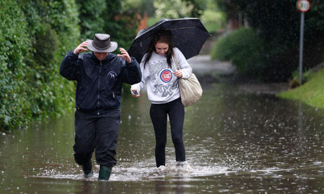 People wade through flood water near Chichester