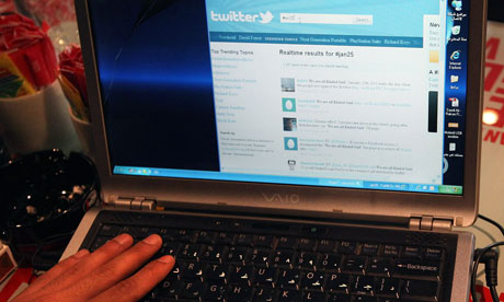 Man uses Twitter on his laptop