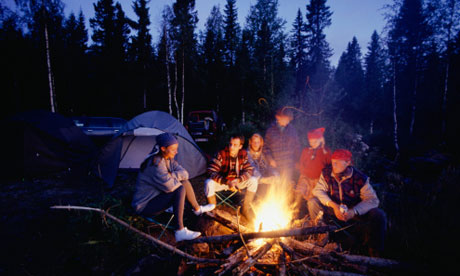 Group sitting round a camp fire