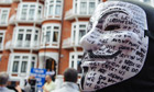 A masked supporter of Julian Assange outside Ecuador's embassy in Knightsbridge, London.