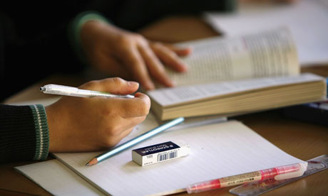 School student writes during maths lesson