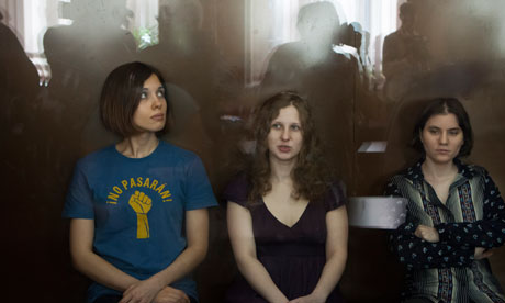 Pussy Riot members, from left, Nadezhda Tolokonnikova, Maria Alyokhina and Yekaterina Samutsevich sit in a glass cage at a court room in Moscow. Photograph: Alexander Zemlianichenko/AP